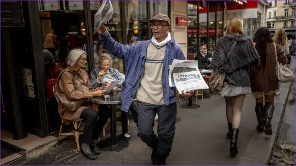 France celebrates last newspaper hawker in paris with knighthood