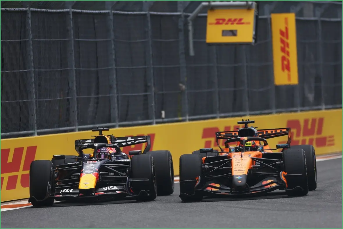 McLaren and Red Bull Join Forces to Address F1 Team Alliance Issues Red Bull and McLaren Formula 1 cars racing closely on a track with DHL branding in the background